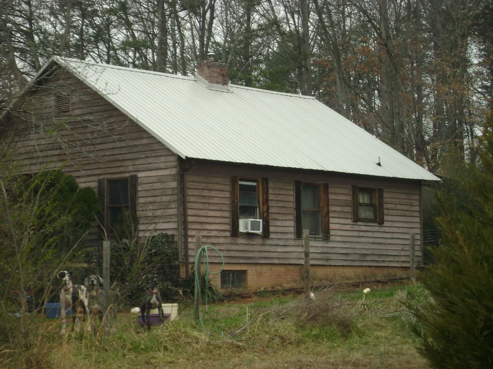 White metal roof on an old wood sided farmhouse, from a Metal Roof Installation job in Fitzwilliam